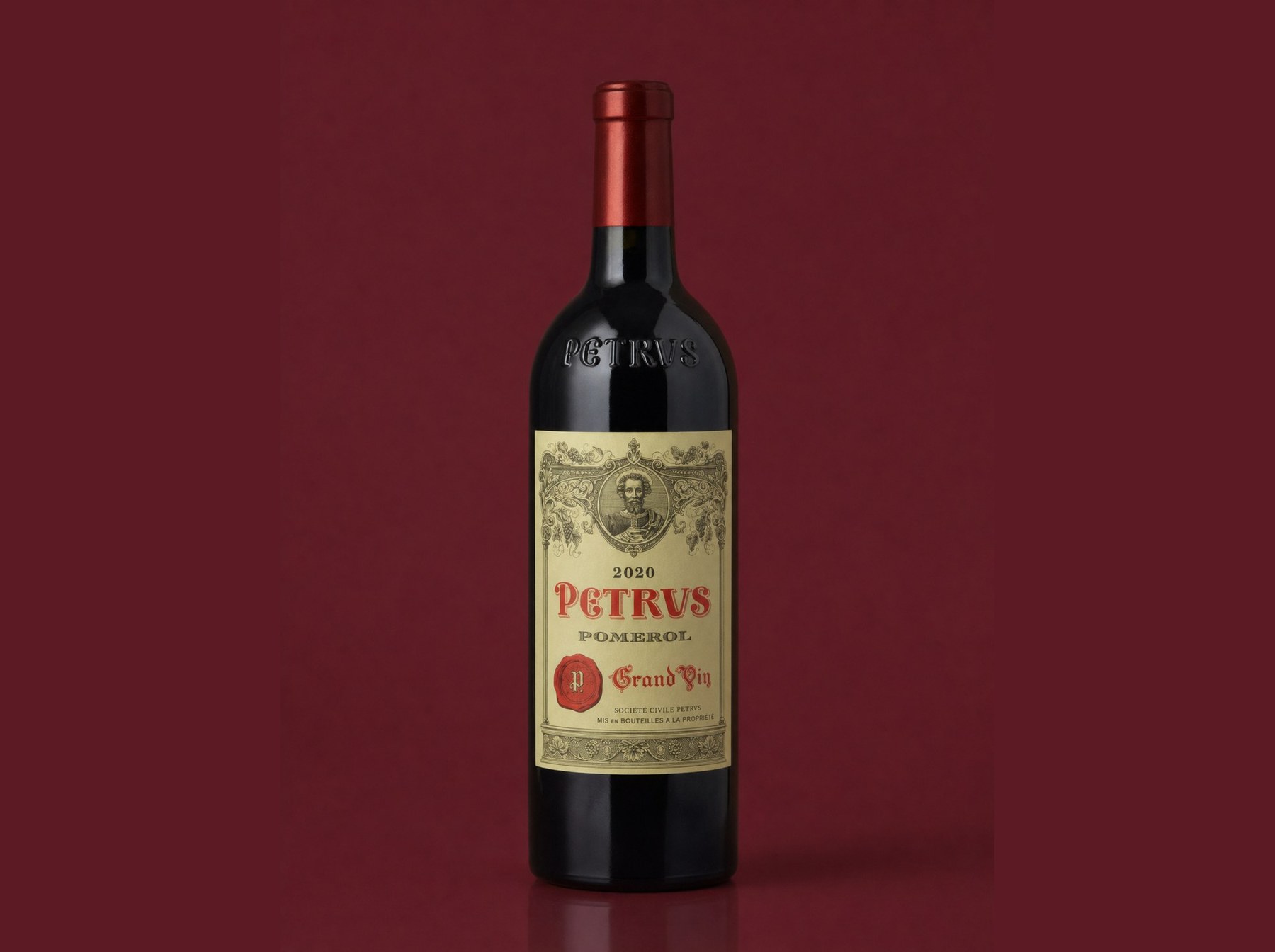 Pétrus - a fine red-wine bottle on a deep wine-red background